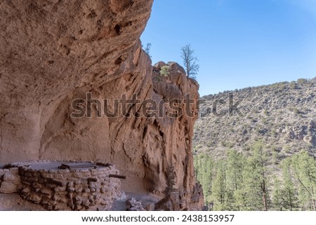 Alcove House at Bandelier National Monument preserves Ancestral Puebloan home in New Mexico. Ceremonial Cave with kiva above Frijoles Canyon. Royalty-Free Stock Photo #2438153957