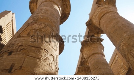 The Temple of Karnak, Luxor, Egypt. Great Hypostyle Hall with Hieroglyphics on Pillar. Royalty-Free Stock Photo #2438156275