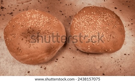 A close-up of a whole fresh crispy delicious round-shaped wheat bread on a white background.