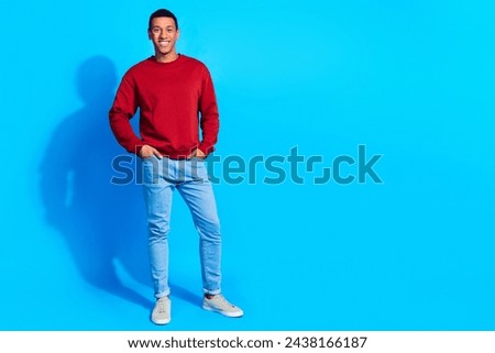 Full length photo of satisfied glad young person put hands pockets posing empty space ad isolated on blue color background
