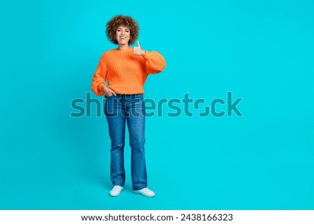 Photo of positive satisfied woman wear stylish clothes recommend boutique store thumb up empty space isolated on blue color background