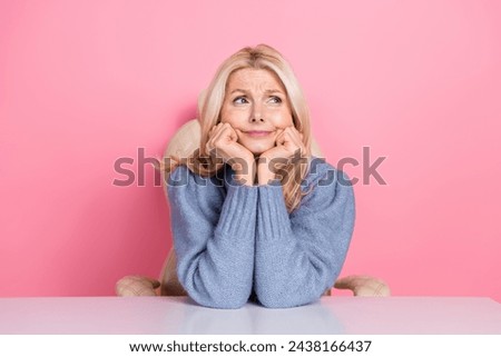 Photo of dreamy cute lady dressed sweater arms cheekbones looking empty space isolated pink color background