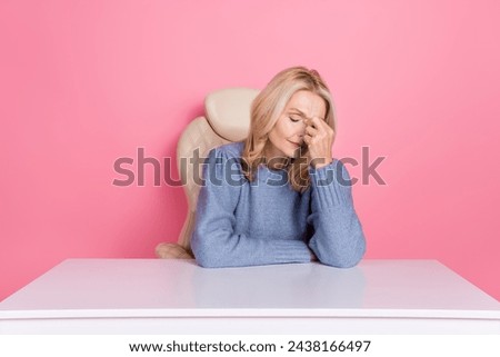 Photo of depressed upset woman wear pullover sitting office feeling sick isolated pink color background