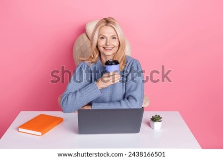 Photo of charming sweet lady dressed sweater texting modern gadget drinking tea isolated pink color background