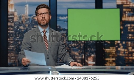 Breaking news reporter talking in front chroma key monitor tv studio closeup. Confident man newscaster pointing hand showing information on green screen. Professional television broadcast concept