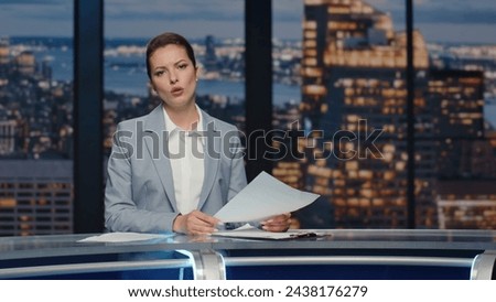 Female newscaster reporting news at late night studio closeup. Professional anchor woman broadcasting day events gesturing hands. Lady presenter talking at live tv channel studio. Journalism concept Royalty-Free Stock Photo #2438176279