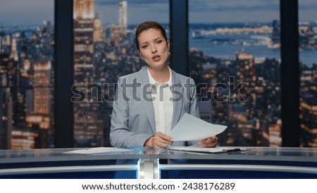Smiling journalist presenting breaking news at night studio closeup. Elegant newsreader lady speaking at newscast television. Anchor woman gesturing hands talking about world political situation Royalty-Free Stock Photo #2438176289