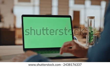 Freelancer hands swiping chromakey laptop at office closeup. Unrecognizable man reading news on green screen computer. Businessman fingers working mockup notebook workplace. Wireless technologies