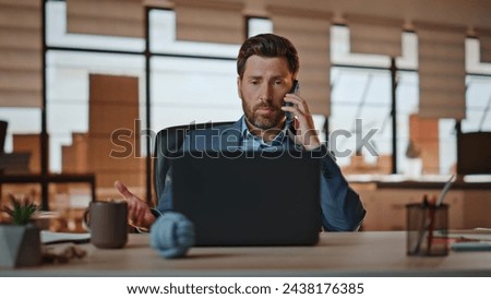 Sales agent talking mobile phone consulting client closeup. Bearded man working office enjoying business conversation at smartphone. Entrepreneur having cellphone negotiation sitting at workplace desk Royalty-Free Stock Photo #2438176385