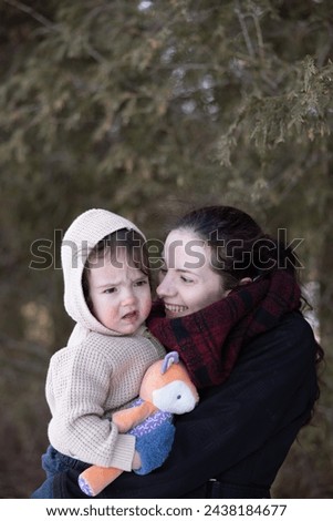 Mother and son in winter apparel Royalty-Free Stock Photo #2438184677