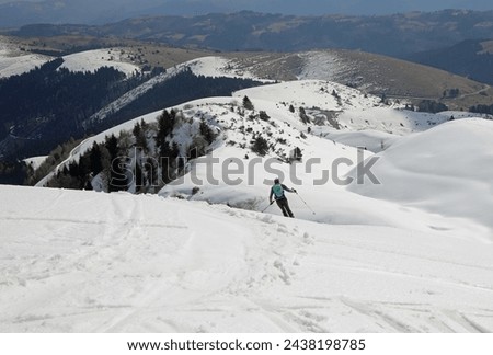 reckless skier going off-piste on fresh snow in the mountains with the risk of avalanches Royalty-Free Stock Photo #2438198785