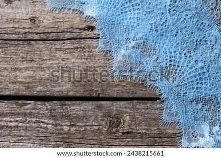 Beautiful lace on wooden table, top view. Space for text