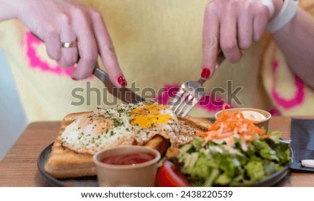 woman eating lunch,woman eats fried egg and toast for lunch