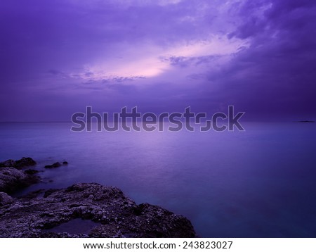 Sea at Night. Smooth Water Photo with  Long Exposure and Purple Filter. Copy Space.