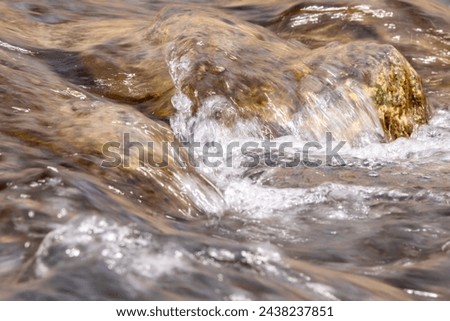Water flowing over rocks in a stream long exposure photography