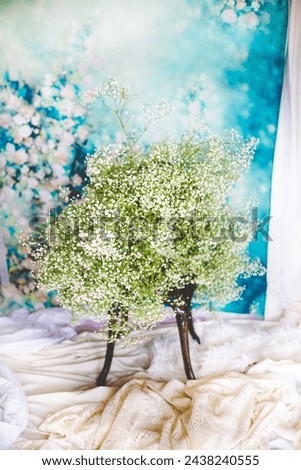 Baby's Breath Bouquet: Huge Bouquet of Baby's Breath Sitting on Metal Chair in Front of Floral Backdrop, Colorful Flower Photography for Spring, Wedding Aesthetic Photography