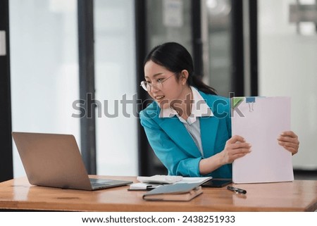 Female financial advisor or accountant  reviews her documents and using laptop. 