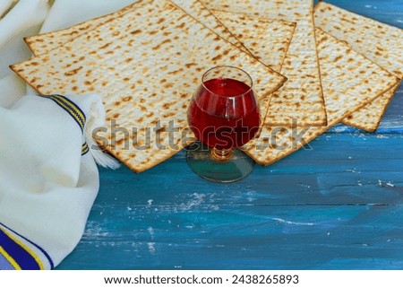 Matzo unleavened bread red kosher wine, symbolizes haste of Israelites departure from Egypt. Royalty-Free Stock Photo #2438265893