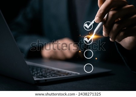 Checklist concept. Questionnaire with checkboxes, filling survey form online. Businessman using pen to checking mark on checkboxes on virtual screen.
