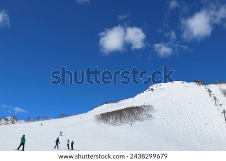 Aerial photography of skiers skiing on a ski resort under the blue sky Planet photography