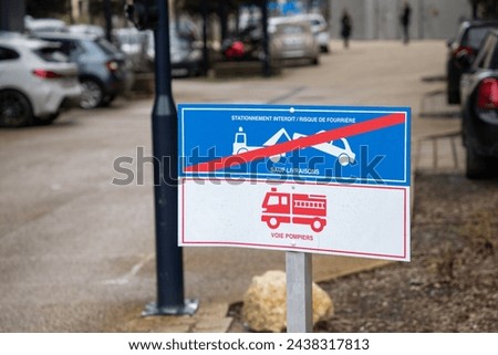 stationnement interdit and risque de fourriere with voie pompier french text means risk car impound Traffic Laws panel vehicle sign evacuation on fire engine access Royalty-Free Stock Photo #2438317813