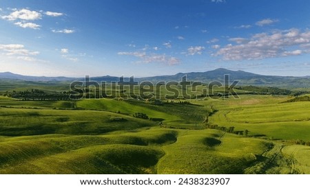 Tuscany aerial landscape of farmland hill country at evening. Italy, Europe Royalty-Free Stock Photo #2438323907