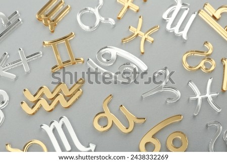 Zodiac signs on grey background, flat lay