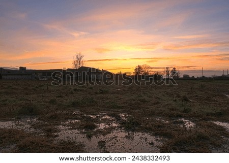 Po Valley sunset farmstead panorama landscape sky color red clouds horizon backlight characteristic nature natural naturalistic history culture tourism Italy Europe Royalty-Free Stock Photo #2438332493