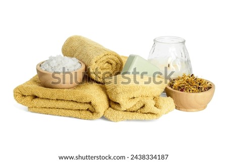 Spa composition. Towels, burning candle, sea salt, soap and dry flowers on white background