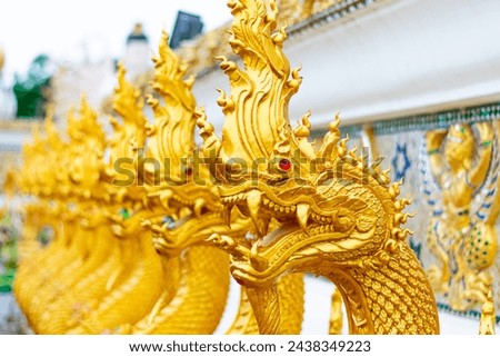 Naga Statue With Buddhist Temple in thailand. Royalty-Free Stock Photo #2438349223