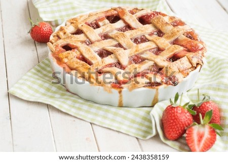 Perfect summer home made pie with rhubarb and strawberry on white background close up selective focus