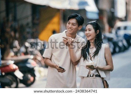Young couple tourists enjoying vacation in local market in small town.