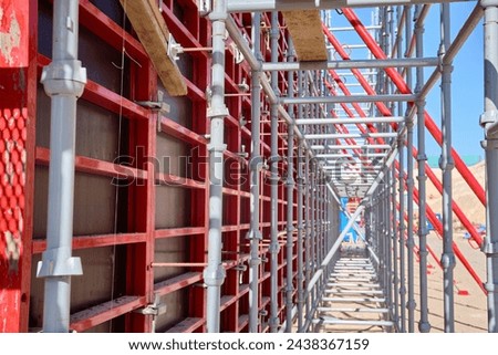 Vertical panel formwork, push-pull jacks and scaffoldings of reinforced concrete walls under construction. Structures for cast in place reinforced concrete Royalty-Free Stock Photo #2438367159