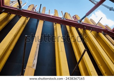Vertical panel formwork and push-pull jacks of reinforced concrete walls under construction. Structures for cast in place reinforced concrete low angle view Royalty-Free Stock Photo #2438367165