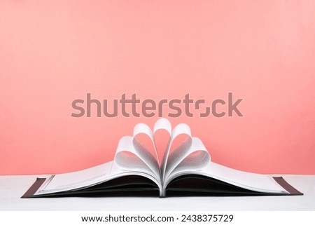 Old open hardback book, page decorate into a flower shape for love in Valentine's. love with open book heart Royalty-Free Stock Photo #2438375729