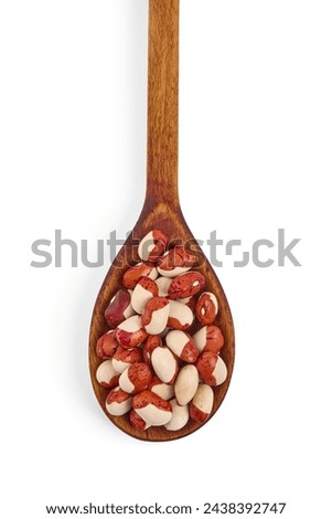 Red Anasazi Beans on wooden spoon, isolated on a white background. Spotted beans. Kidney beans Royalty-Free Stock Photo #2438392747