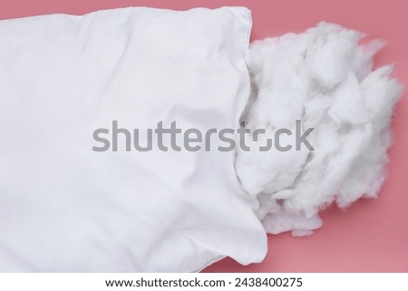 White pillow with polyester stable fiber on pink background. Royalty-Free Stock Photo #2438400275