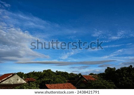 Beautiful cloudy blue sky high resolution background with houses roof at bottom foreground