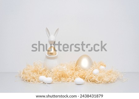 Golden ester bunny decor holiday concept thatch and eggs