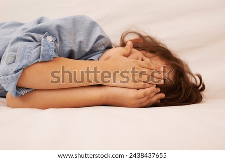 Young child, hands over face and playful at home, peek a boo or hiding with childhood and innocent. Games, hide and seek with youth, covering eyes and kid playing, silly or goofy with blind emoji Royalty-Free Stock Photo #2438437655