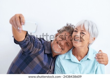 Old couple, selfie and hug, happy together and social media post for memory and love on white background. Trust, support and loyalty with people in marriage, smile in picture for post and mobile app