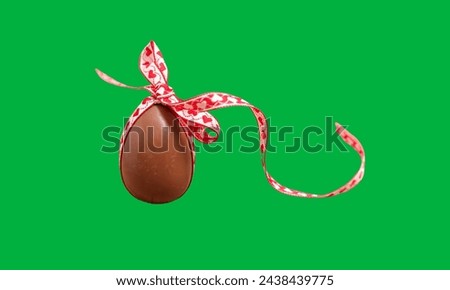 Easter chocolate egg with ribbon band on green screen 