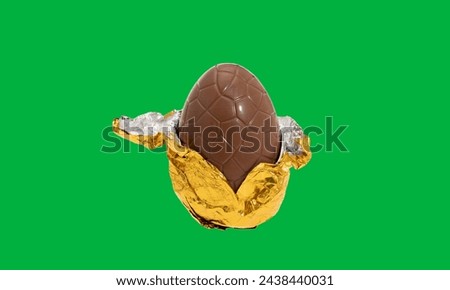 Chocolate easter egg with gold cover half open on green screen 