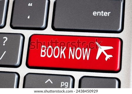 Book now text on red keyboard. Traveling concept. Royalty-Free Stock Photo #2438450929