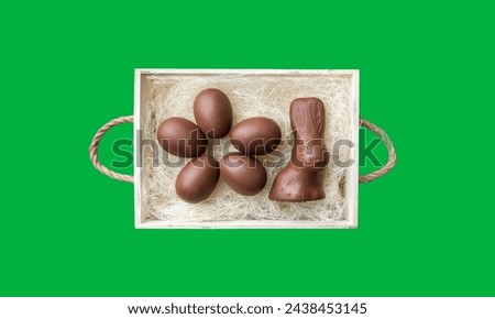 Chocolate easter egg and easter bunny in box on green screen 
