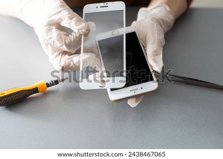 Technician prepairing to repair and replace new screen broken and cracked screen smartphone prepairing on desk.