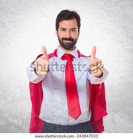 Businessman dressed like superhero with thumb up 
