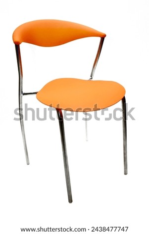 Modern orange chair, with chromed metal structure.