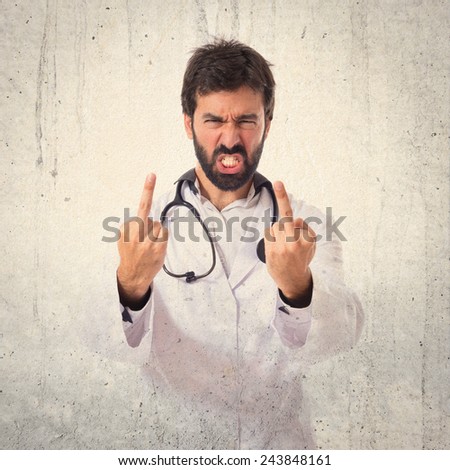 Doctor making horn gesture over textured background