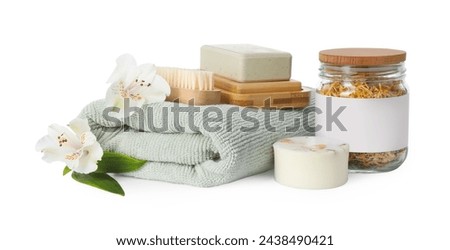 Spa composition. Towel, personal care products, brush, fresh and dry flowers on white background